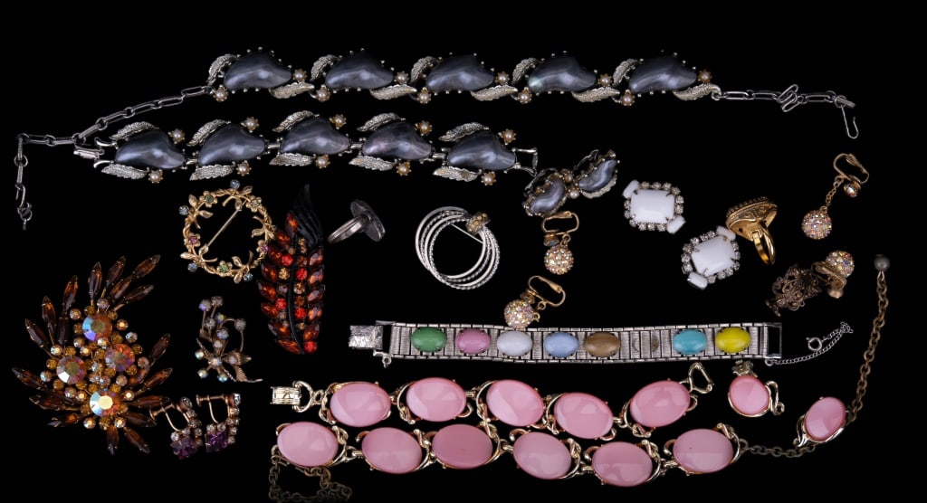 Coro & Other Costume Jewelry: Early signed Coro necklace with silver blue hue pearls, and matching bracelet and earrings; set is Parube, pink unsigned set, a large unsigned vintage cognac to red orange hue brooches, clip earrings,