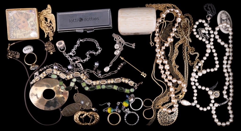 Costume Jewelry: Costume Jewelry including 9 necklaces, 4 rings. 5 pairs of earrings, 4, bracelets, 3 pins, and a pendant. Lot also includes an ivory colored jewelry box and a Lotti Dotti set with box.