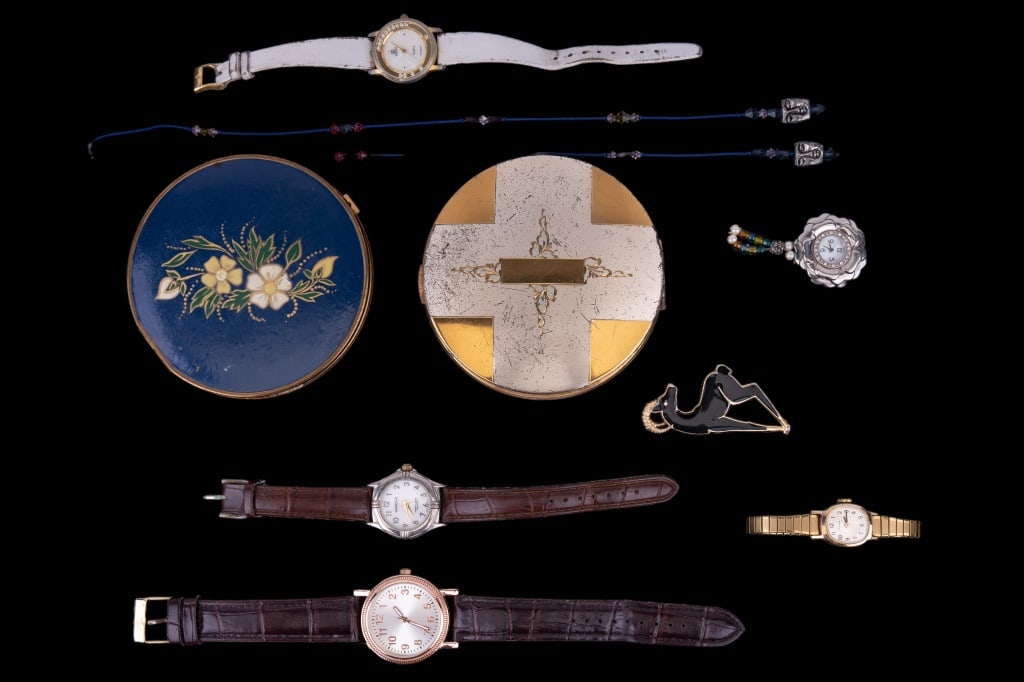 Vintage Compacts, Watches & Trifari Brooch: Two vintage compacts including gold tone compact has a broken interior mirror, watch marked "watch-it" nightlight quartz with Japanese movement, Japanese watch without band, Trifari black enameled gol