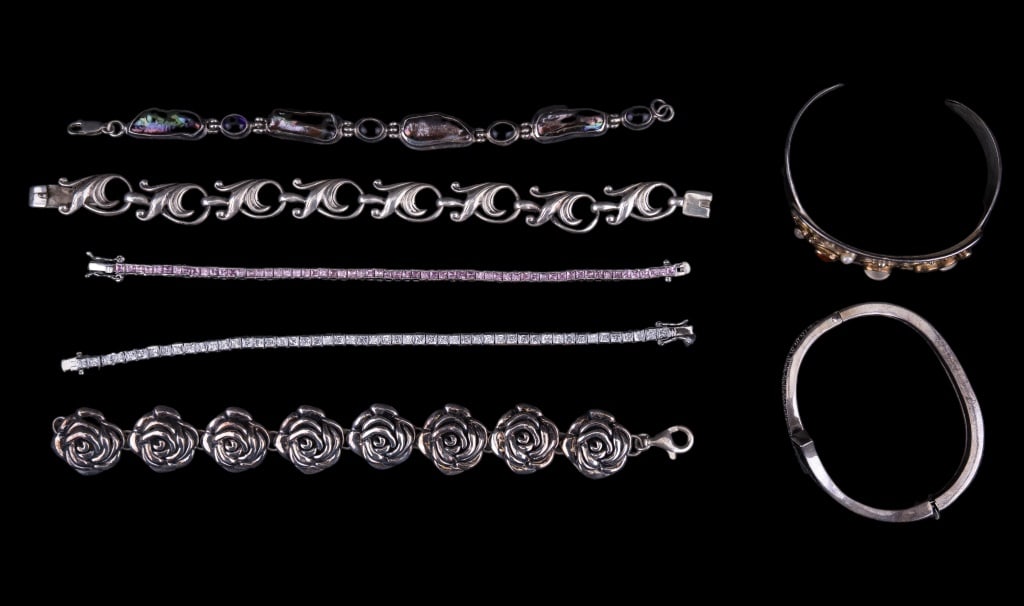 Sterling Silver Semi Precious Bracelets & More: 7 sterling silver marked bracelets including hinged bangle, cuff and 5 dangle. One bracelet holds abalone and amethyst, 2 more with pink and white crystal / CZ stones, hinged bangle with marcasite and