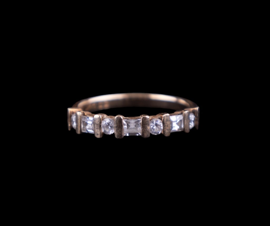10K Gold Cubic Zirconia Ring: 10K yellow gold bang ring with 7 cubic zirconia stones. Ring approx size 6.5. Total weight approx 2.5g.