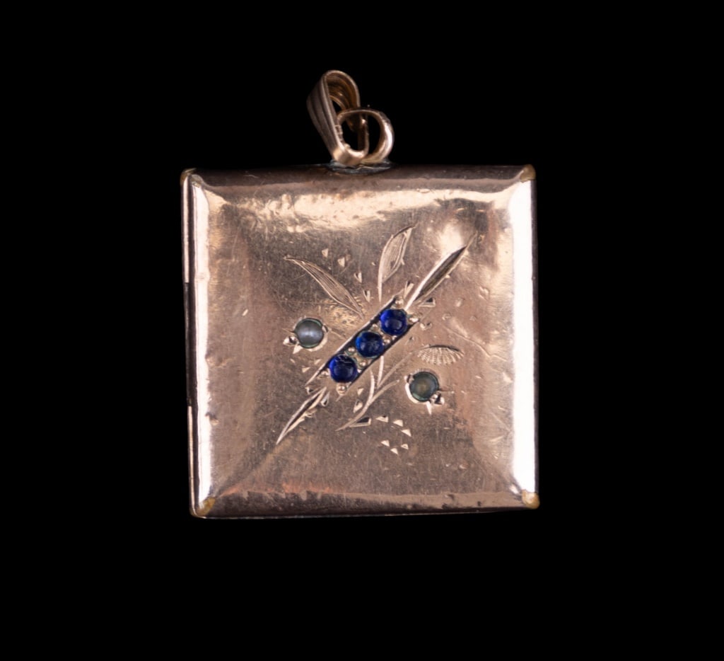 14K Gold Locket Pendant: 14K yellow gold pendant in the shape of a book accented with stones that test in the range of glass. One side is monogrammed. There is one photo inside of the locket. Locket opens and closes well. Whe