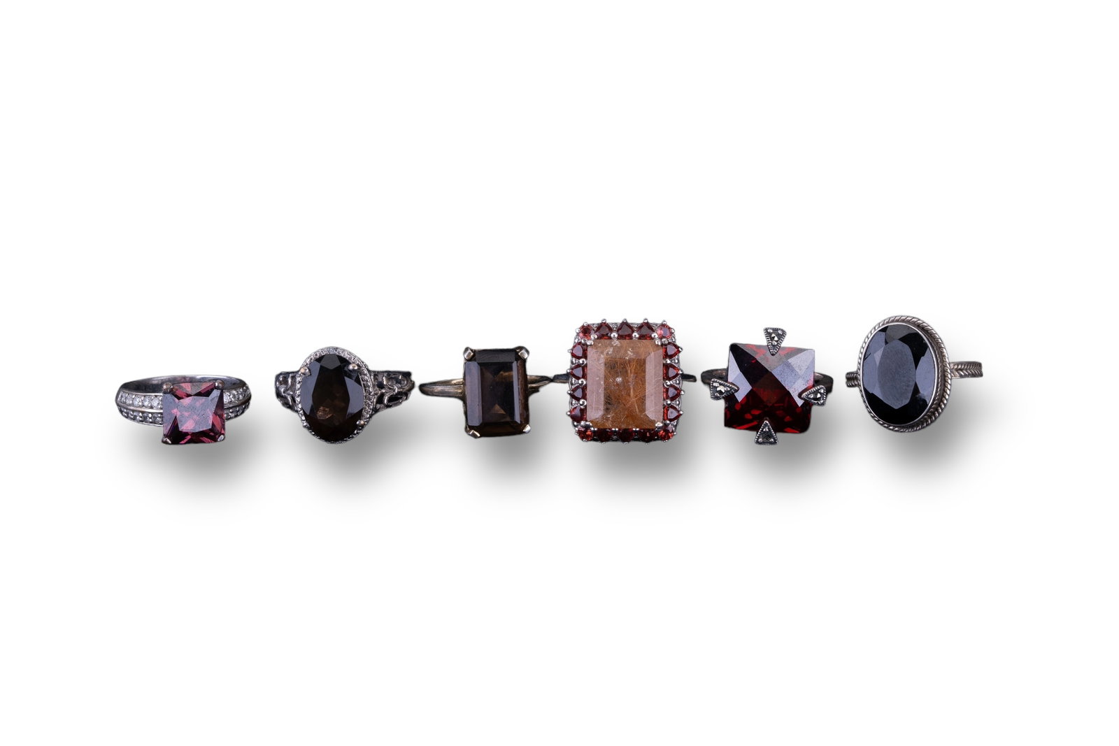 Sterling Semi-Precious Rings (6): 6 Sterling silver semi-precious rings with stones including onyx, garnet, smoky quartz and more.