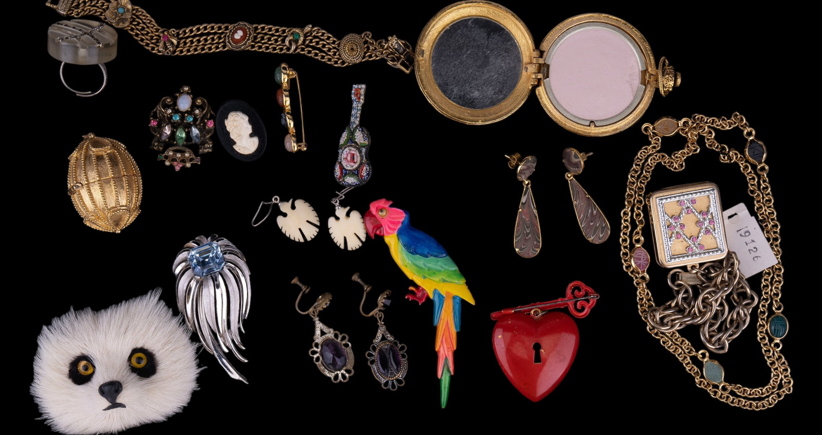 Trifari & Vintage Estate Jewelry: Signed Trifari angel wing brooch, STL Bros heart pin, Estee Lauder vintage perfume with tassel, purple screwback scarab earrings, panda brooch, music box bracelet, and more.