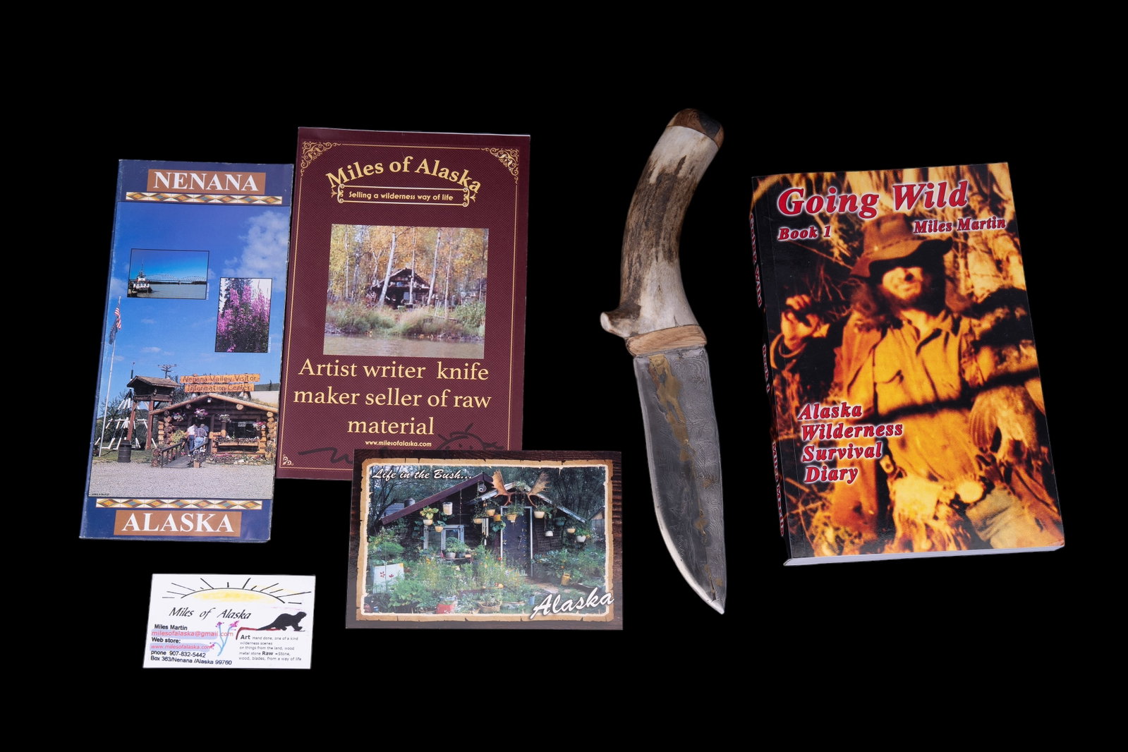 Alaskan Artisan Made Custom Knife (OOAK): One of a kind (OOAK) artisan made Alaskan knife with antler handled Damascus steel blade with highlights of brass and etched scenery on blade. The handle is antler and burl wood. Maker: Miles Martine 