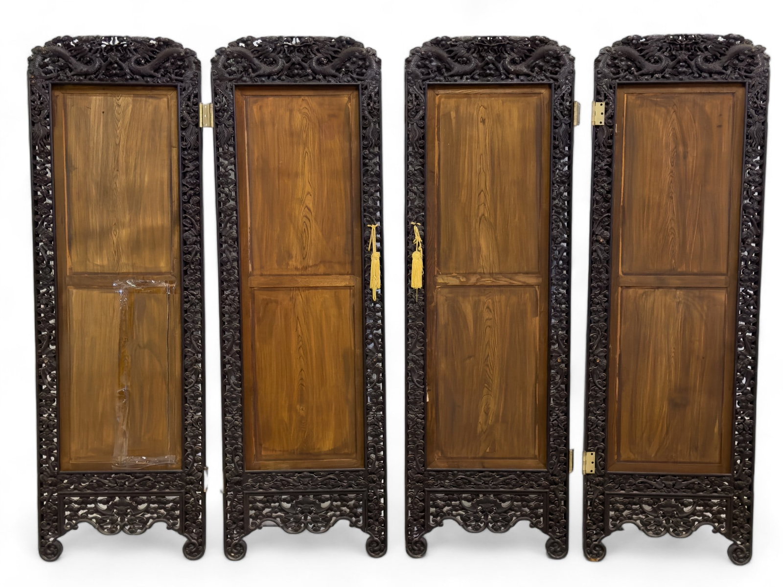 Decoratively Carved Asian Screen: A decoratively carved Asian screen depicting dragons and bats on a floral background. Each screen section measures approx. 72? high, 23? across, 1? deep.