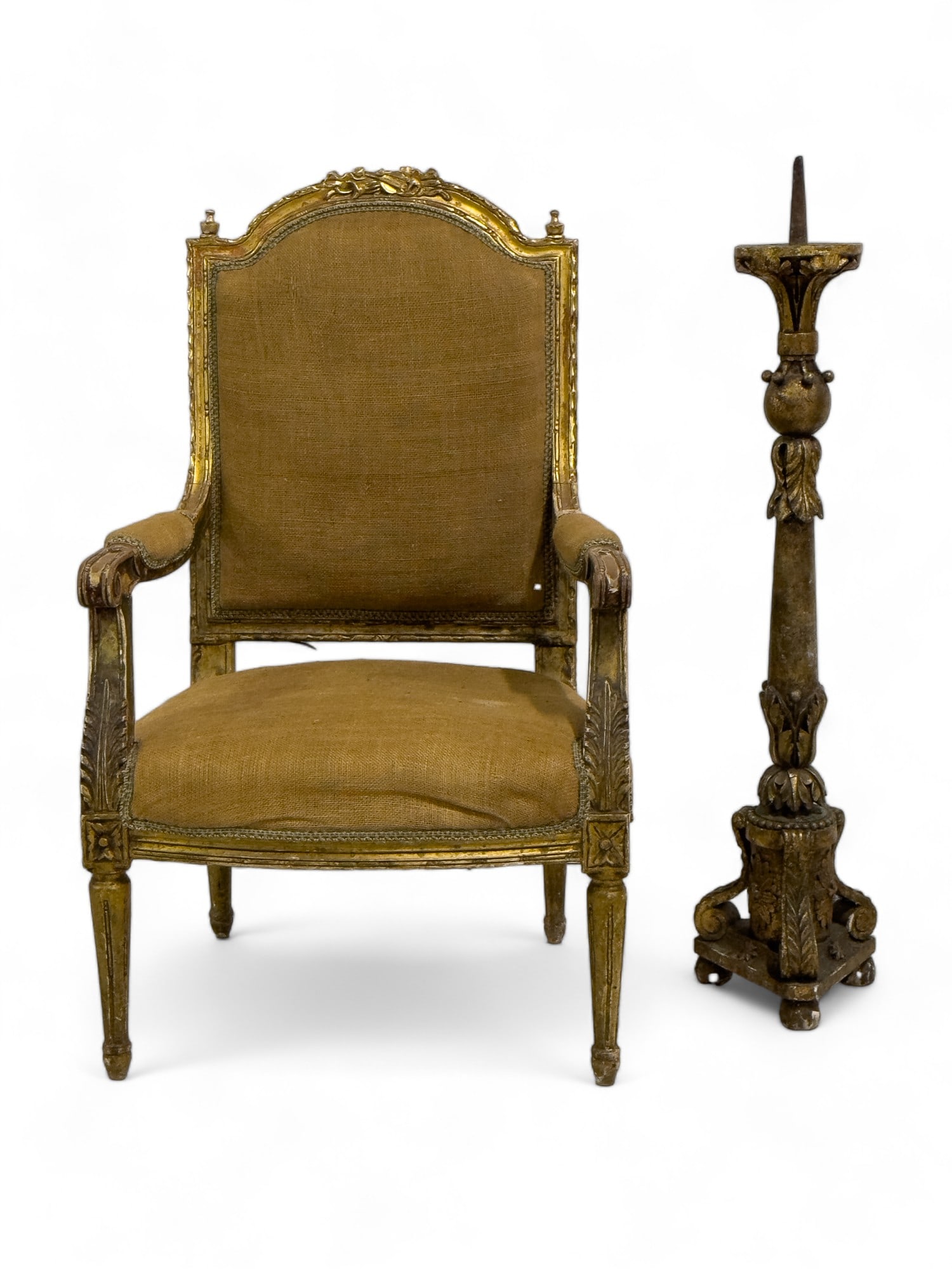 Gilded Armchair w/ Carvings, Tall Candle Stand: A gilded armchair with bottom and back cushions. Chair has laurel carvings, and what looks to be a violin. Chair measures approx. 41.5? high.