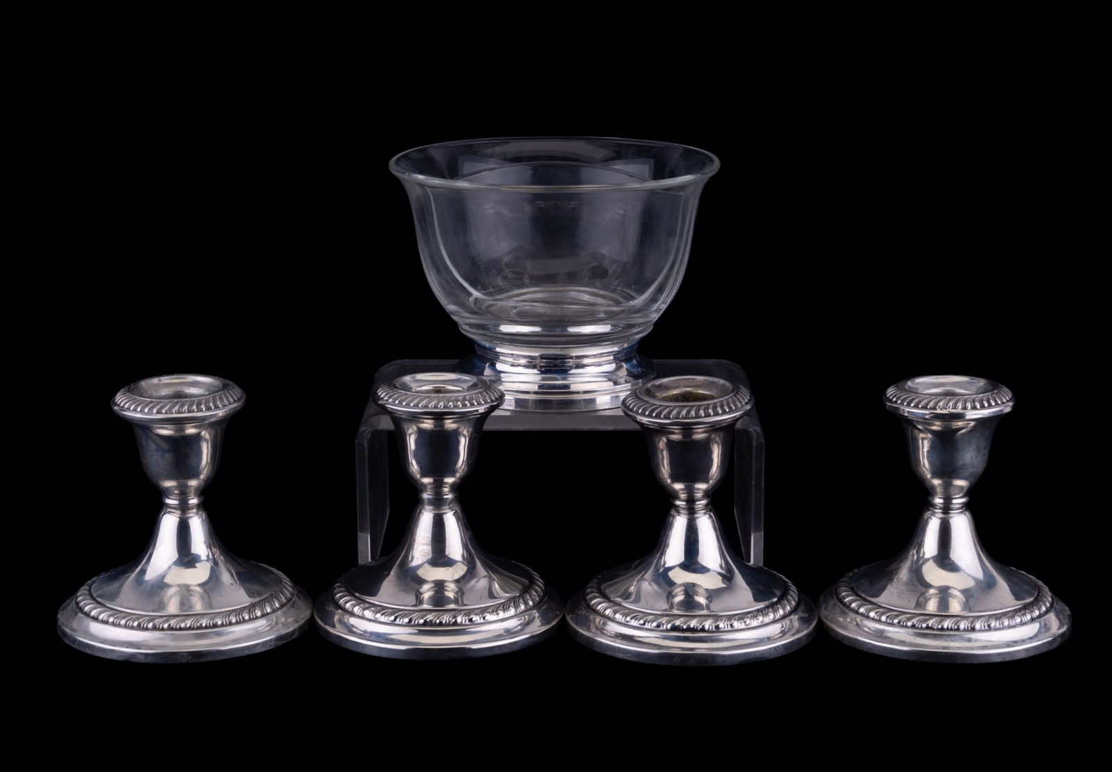 Gorham Sterling Silver Candle Stands & Bowl: Four matching Gorham sterling silver weighted candle stands, each measuring approx 3.5" H. Two stands have small dents (one under the mouth and another on the base). Also includes a nut bowl marked st