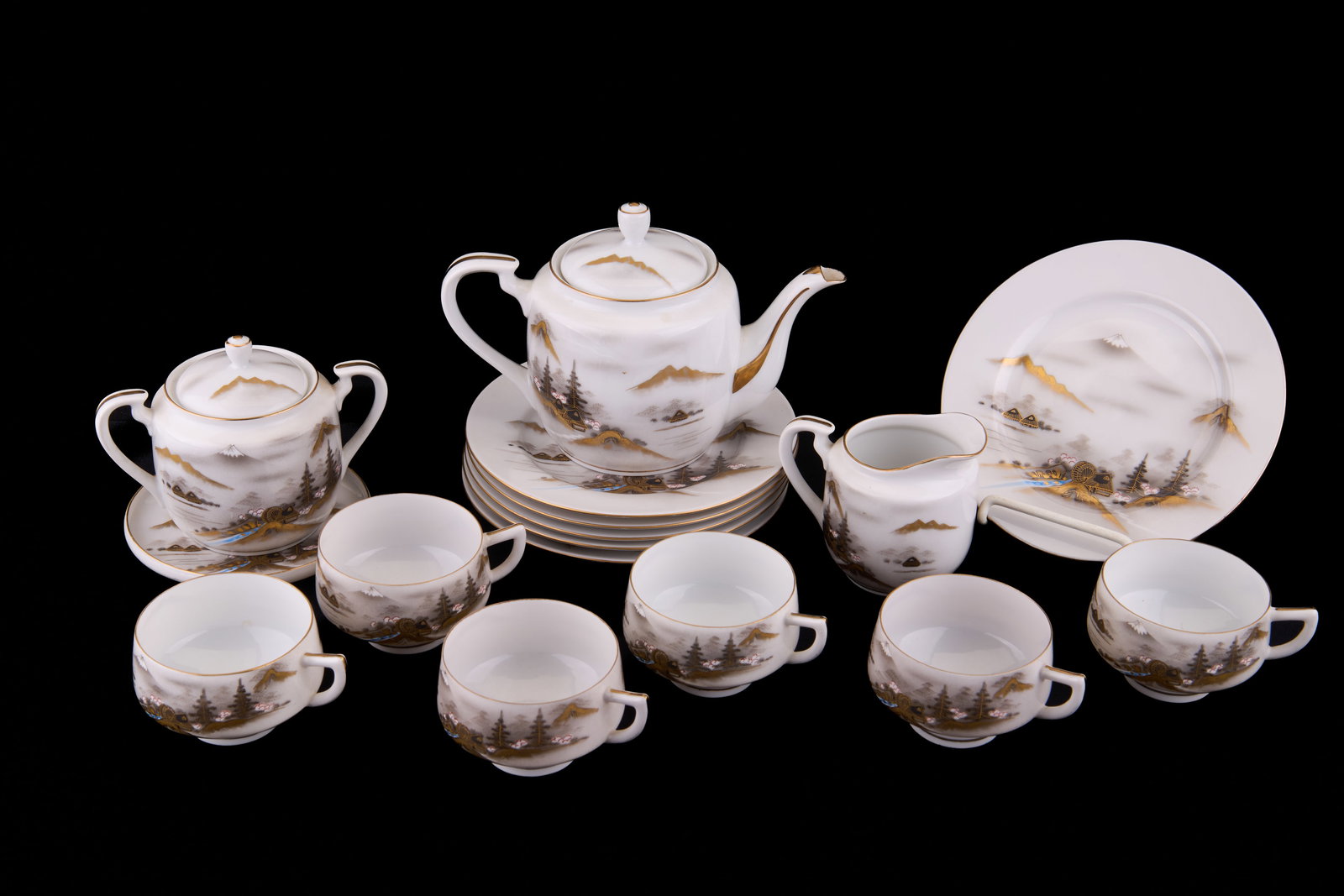 Japanese Tea Set: Japanese tea set including (1) creamer and sugar set, (6) plates and saucers, a teapot and (6) cups.