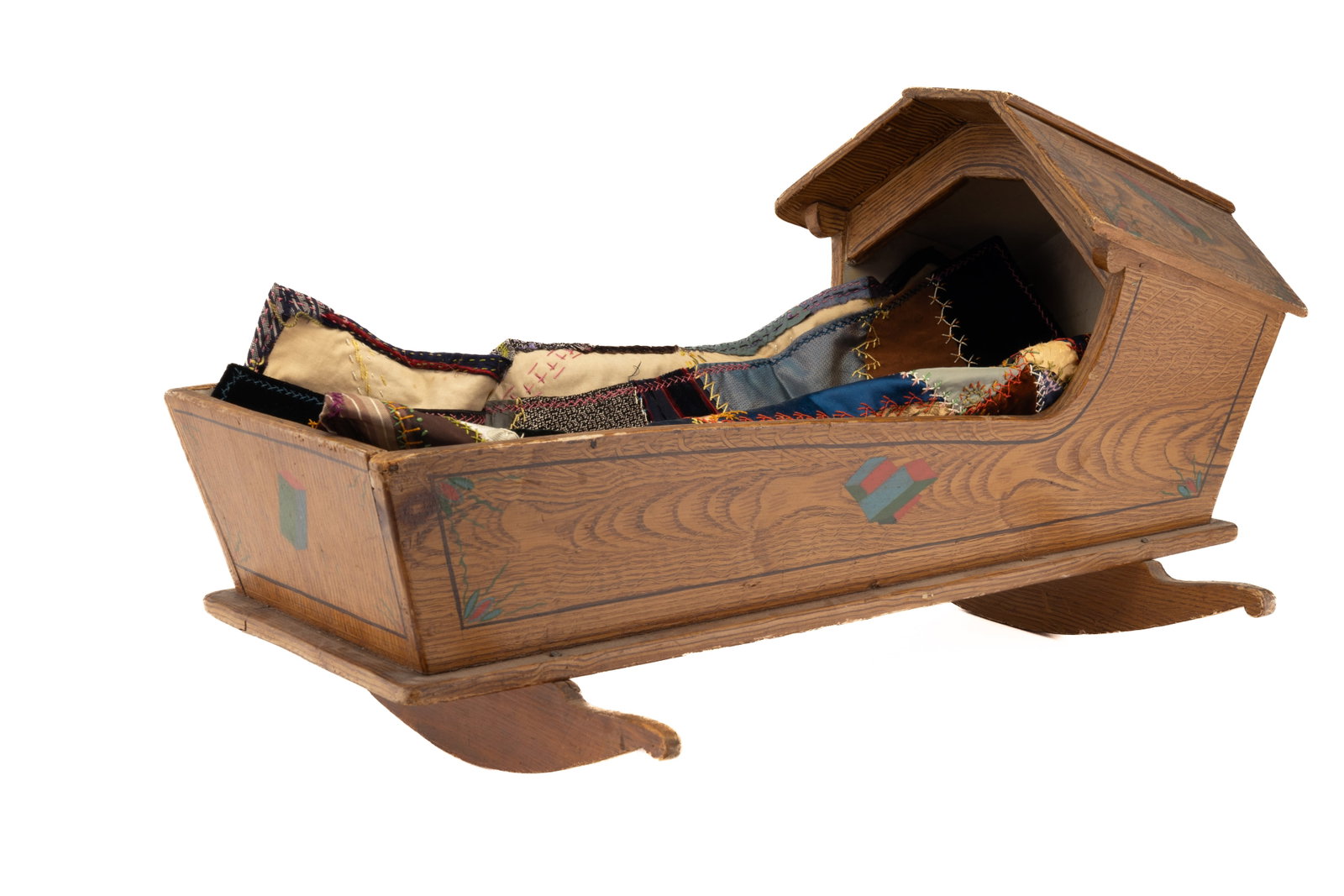Small Crazy Quilt and 19th C Grain Painted Cradle: 19th Century doll cradle (approx 12" H x 14" W x 24" D. lined with hand sewn 19th / 20th century signed doll sized crazy quilt. Signed "Mrs. H.S." (approx 22" x 22").