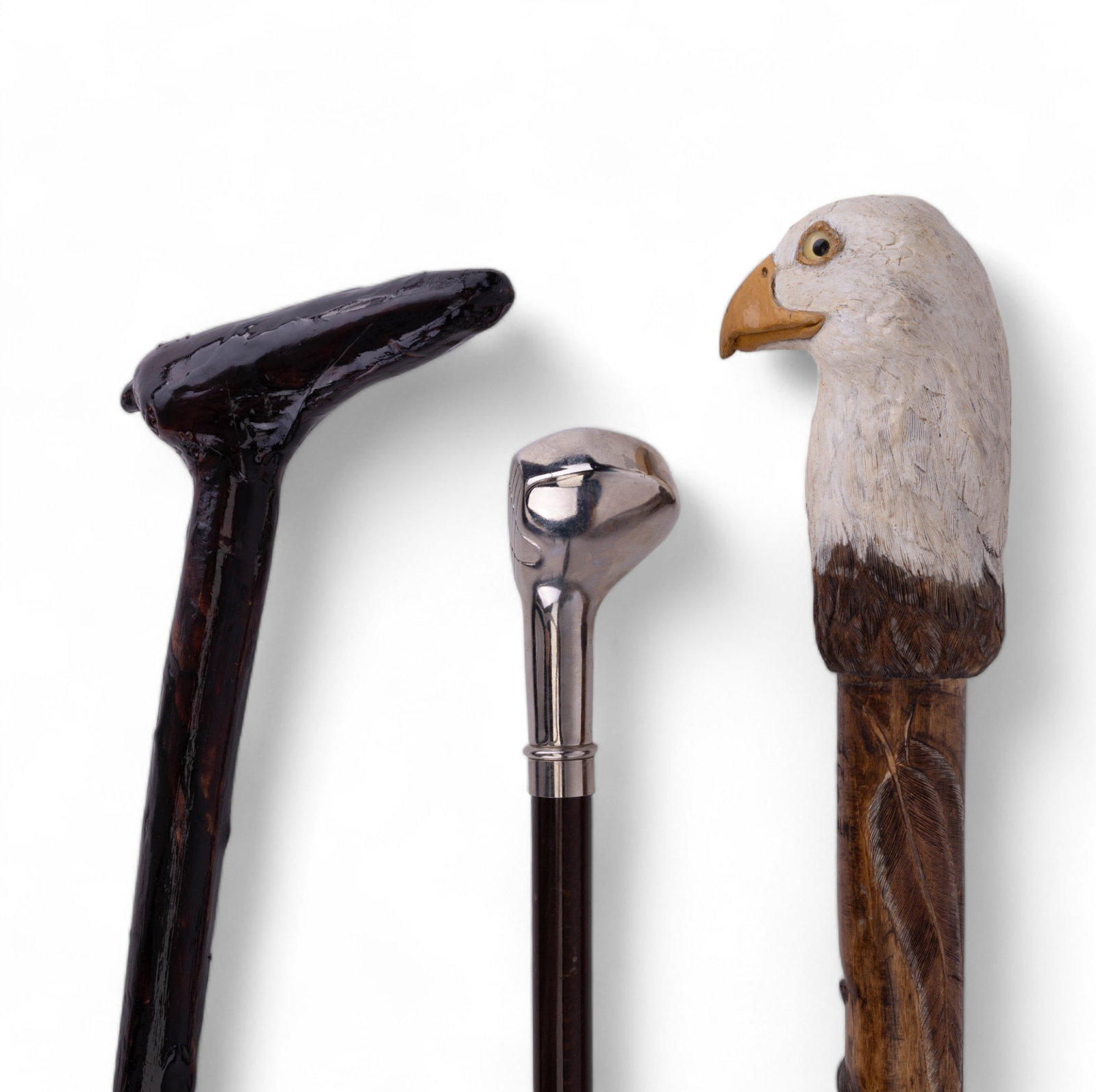 Handled Carved Canes (3): Includes 3 canes with handles of bald eagle, golf club and another. The longest measures approx 51" L.
