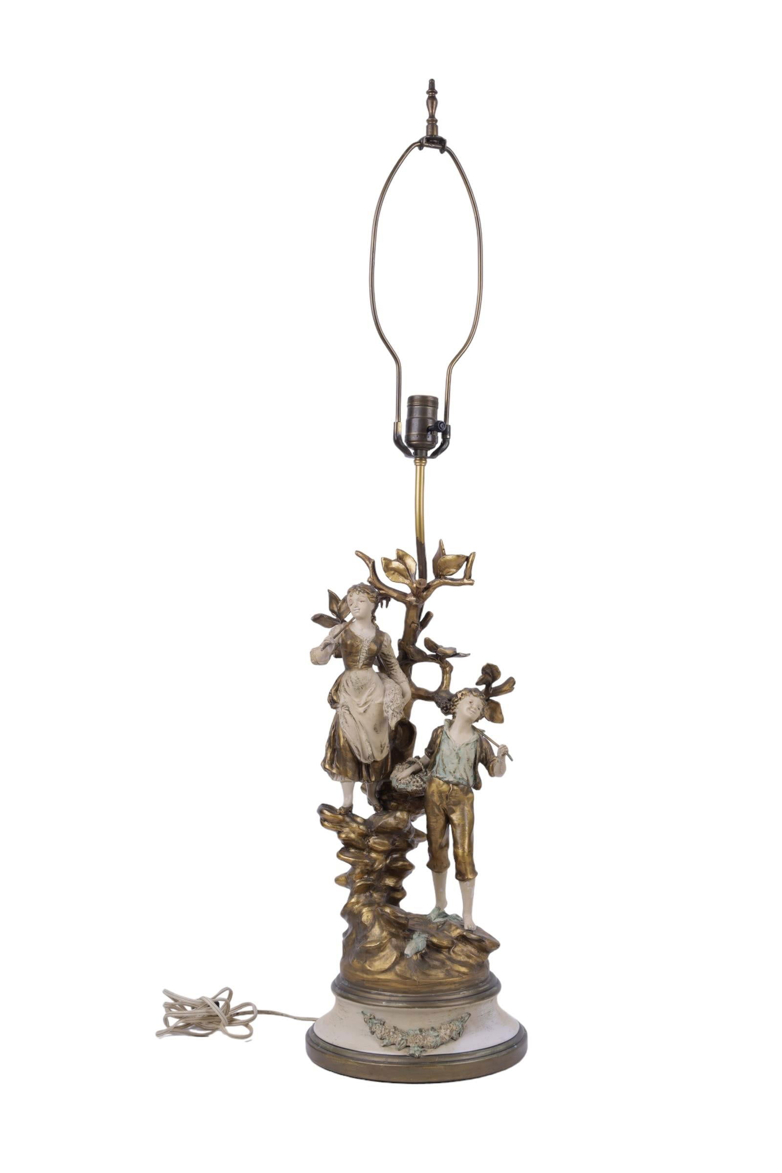 Moreau Francaise Figural Lamp: Painted metal table lamp feature boy and girl carrying garden tools . Marked L & F Moreau. Also has a stamp "Collection Francaise made in USA". 39 3/4" H and figure measures 20 1/2" H Special consider