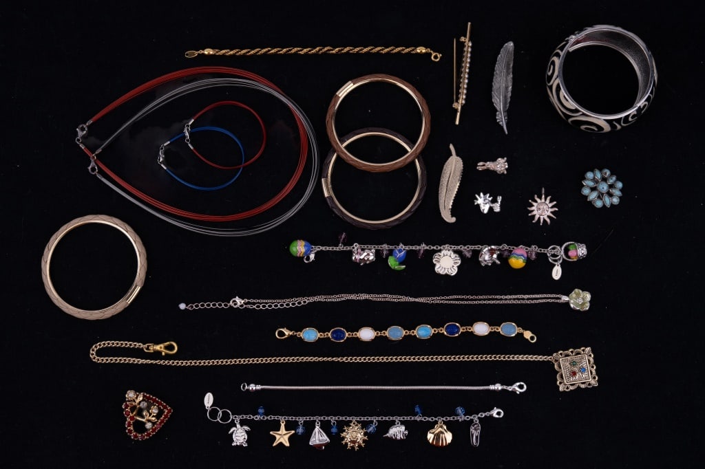 Sterling Charms & More Jewelry: Costume jewelry including an Easter themed charm bracelet with three additional charms that are sterling silver. Also includes a pocket watch fob, brooches, bangles and more.