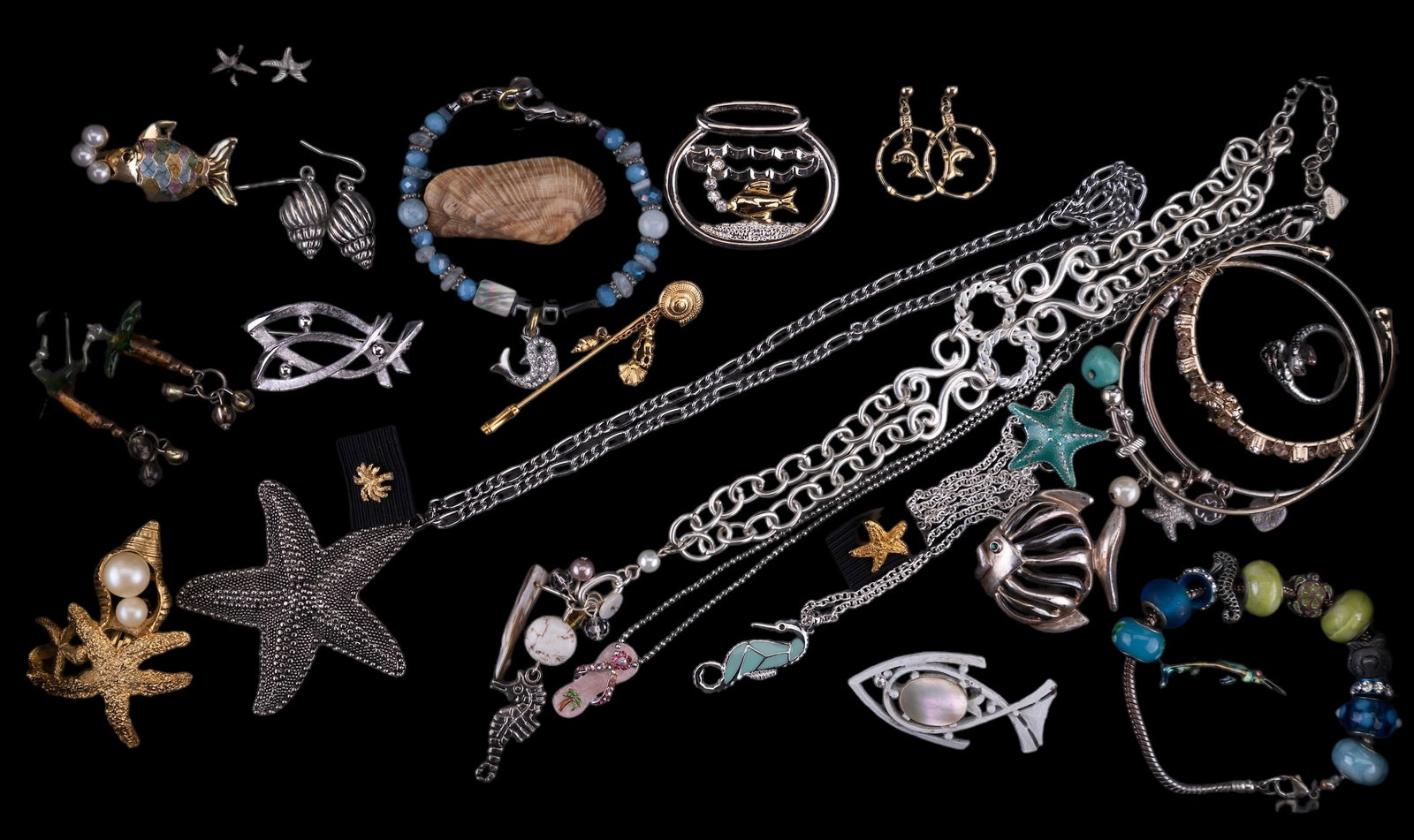 Fish, Starfish, Seahorses, & More: On vacation at the beach with costume jewelry featuring a 2" vintage Hedy silver tone stylized fish pin, a 2" vintage white fish with MOP body and rhinestone eye, a Cookie Lee flip flop necklace, a me