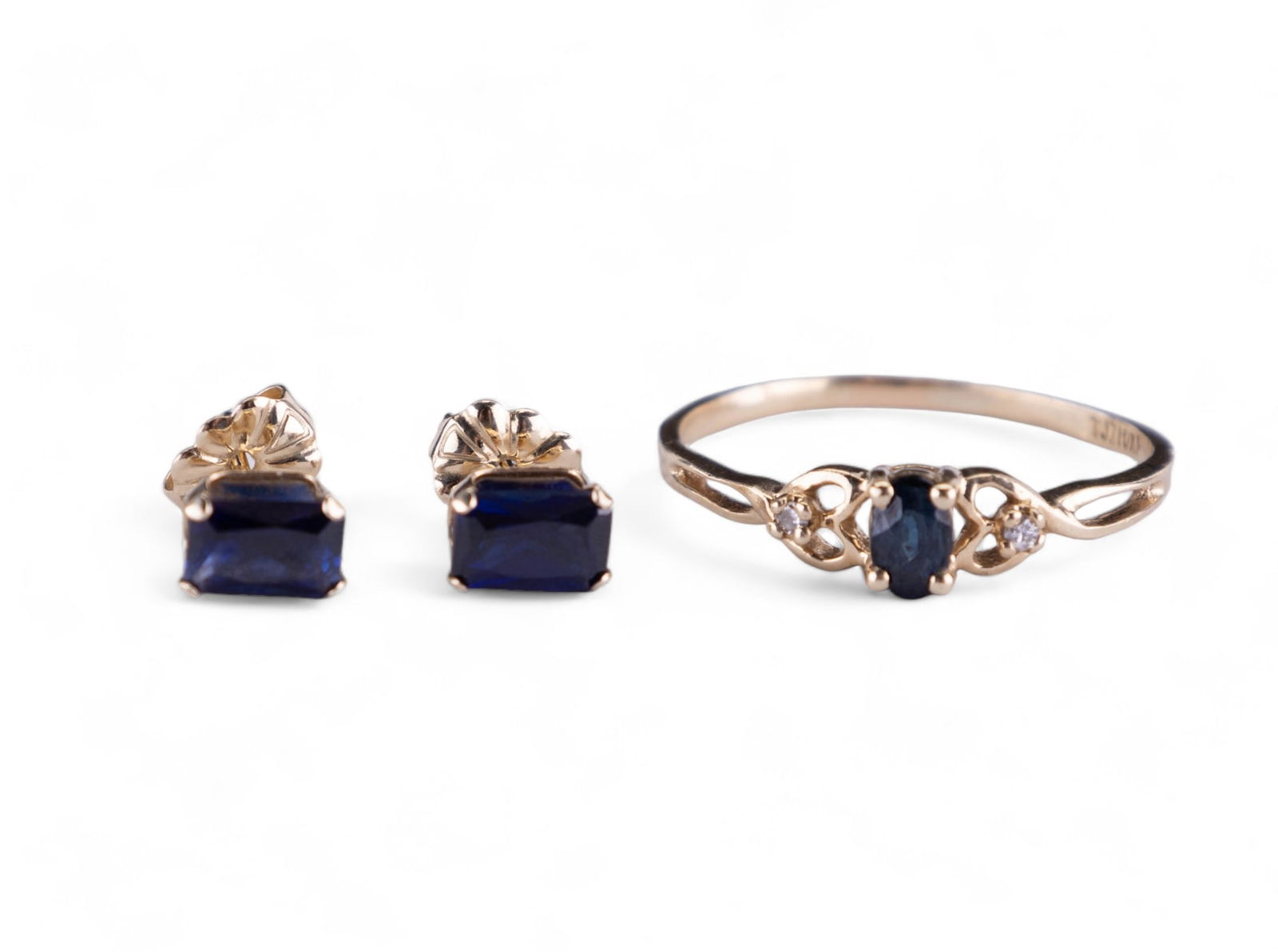 10KP & 14K Gold & Sapphire Ring & Earrings: A 10KP gold size 8.75 ring with a center sapphire and 2 accent diamonds. Sapphire is approx. .35 carats and ring is .88 DWT. A pair of 14K gold sapphire stud earrings with emerald cut approx.4x6mm (ap