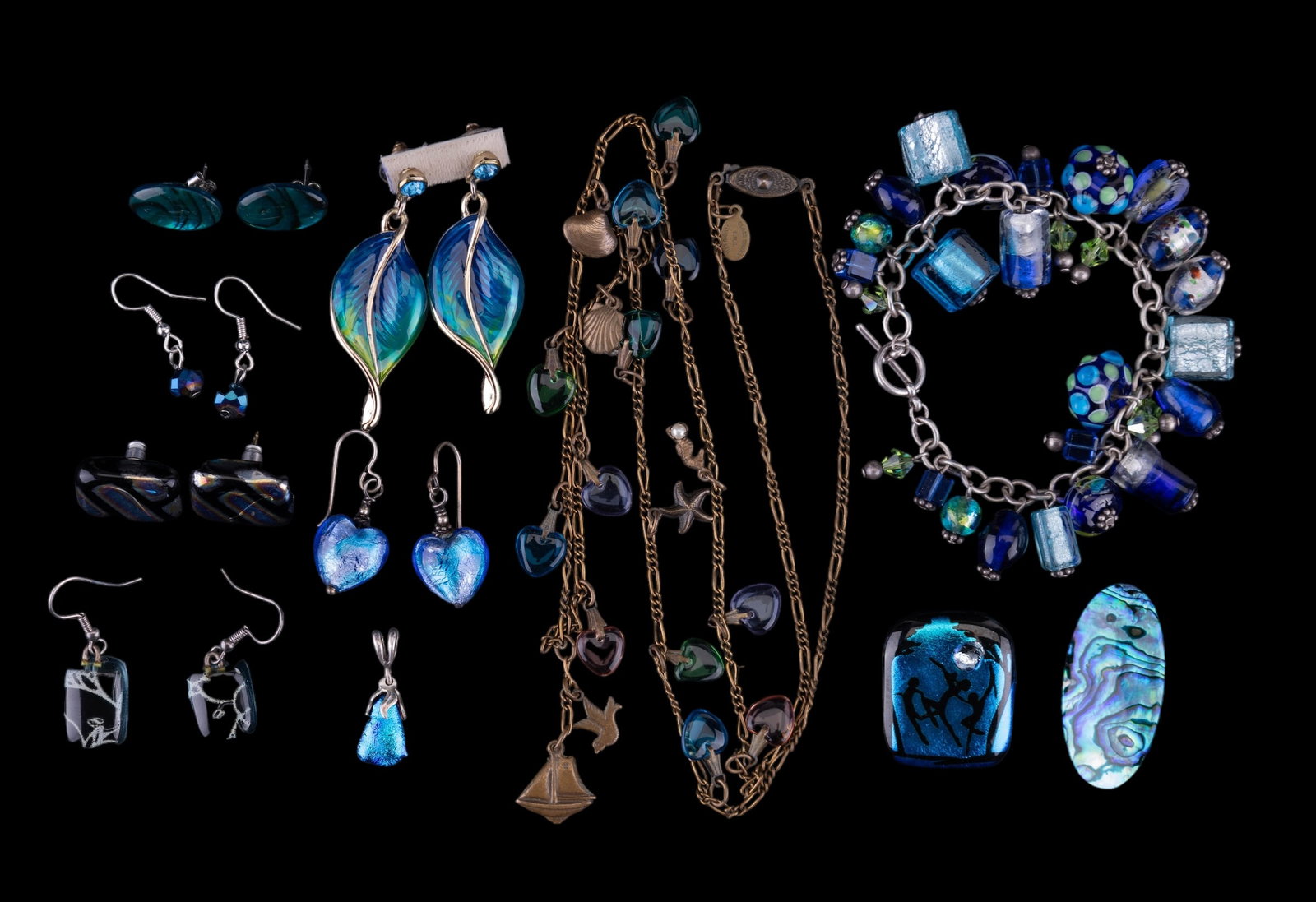 Glass Works Studio, Fused Glass & More: A 30" Glass Works Studio Ltd. sea and sailboat themed necklace, a 1 1/2" oval New Zealand paua shell pin, a 7 1/2" glass lamp work beads and fused glass beads charm bracelet, and more.