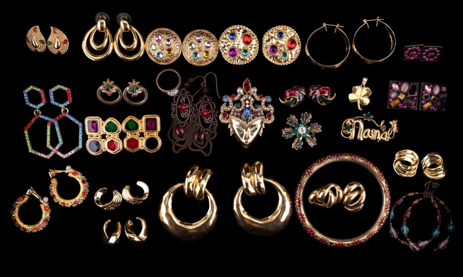 Les Bernard, Trifari, Monet, Coro, and More: 25 pieces of costume and name brand jewelry featuring a Les Bernard 2 1/4" pin of Buddha goddess Tara with green rhinestone eyes and multi colored rhinestone headdress, a pair of Trifari clip triple c