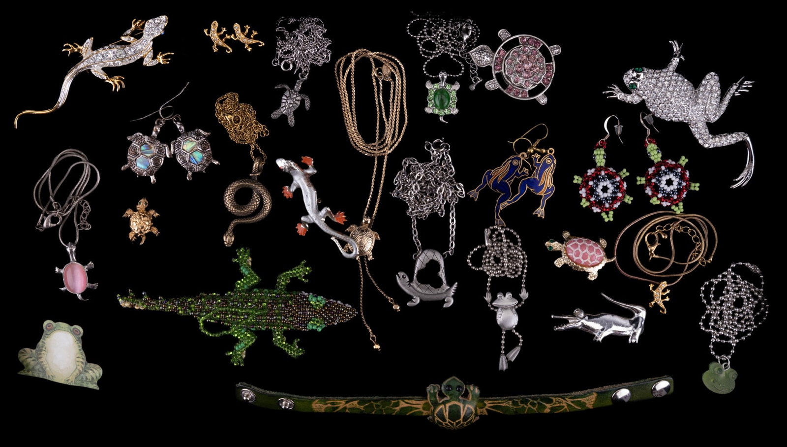 Lizards, Turtles, Frogs, Gators, & More Jewelry: 23 items of costume jewelry including lizards, turtles, frogs, alligators, and one snake. A featured 3 1/2" rhinestone lizard pin with blue eyes stamped 1999 (copyright symbol) P.S. Co., a 7/8" Monet 