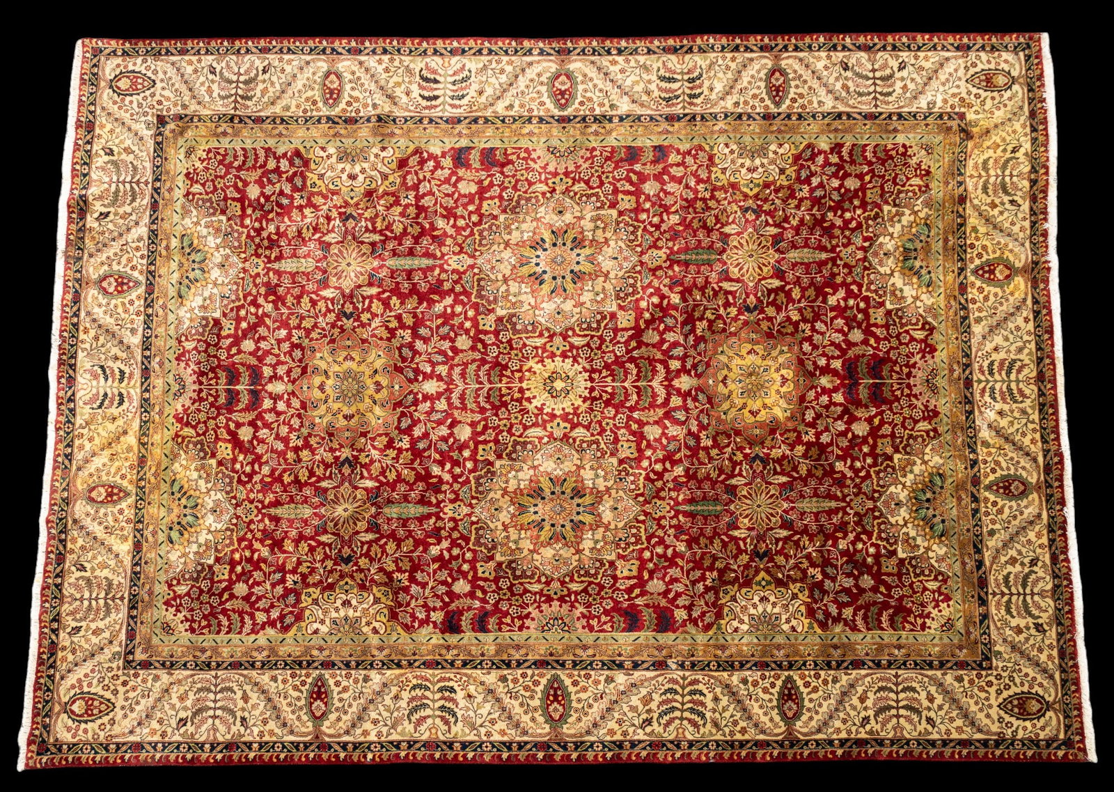 Hand-knotted Persian carpet: Hand-knotted Persian carpet, primarily reds and cream. Approx 8'9" x 11'9", some staining.