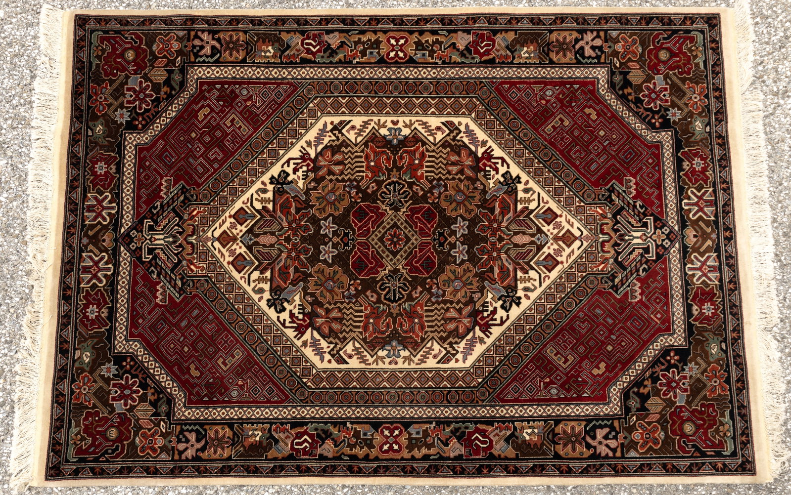 Finely hand-knotted Persian carpet: Finely hand-knotted Persian carpet, with Arabic symbols & animals. Red, beige, teal, & rust medallion with black and red border; thick pile. Pande Cameron Classic; wool. Measures approx 49.5" x 72".