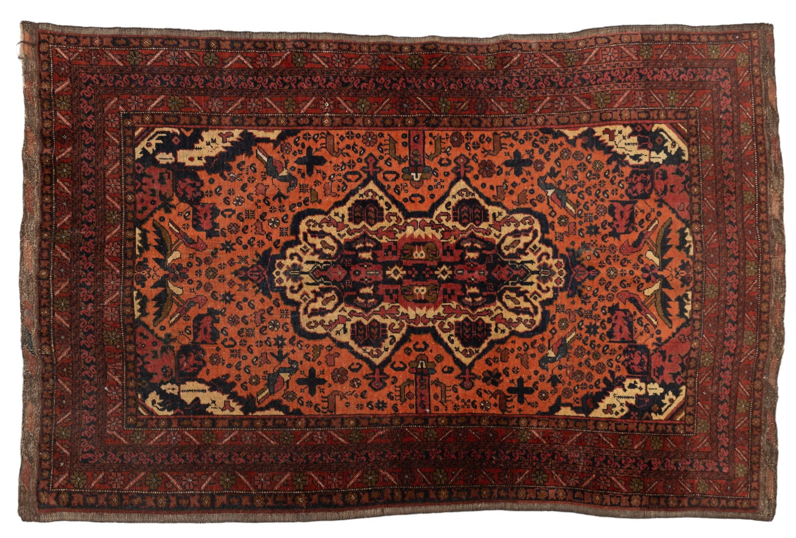 Persian Rug w/ Bird Decoration: Persian carpet, primarily reds with blue and green, flower and bird decoration. Measures 36" x 64". Some loss to pile & fringe.