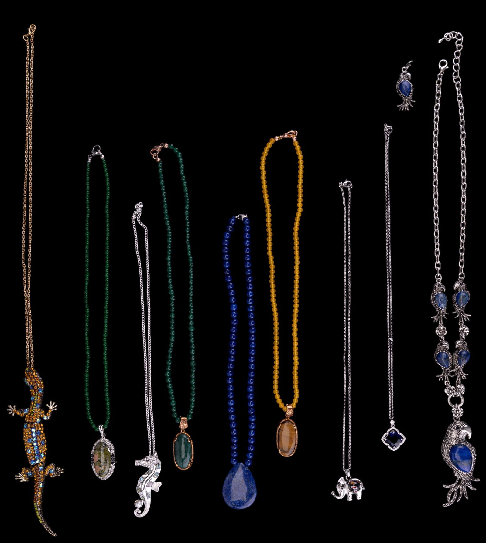 Jade, Lapis & More Necklaces: 19 costume jewelry necklaces including some with semi-precious stones. Some stones test within the range of lapis, jadeite, tiger eye, citrine, abalone, glass. One necklace has a tiger eye pendant on