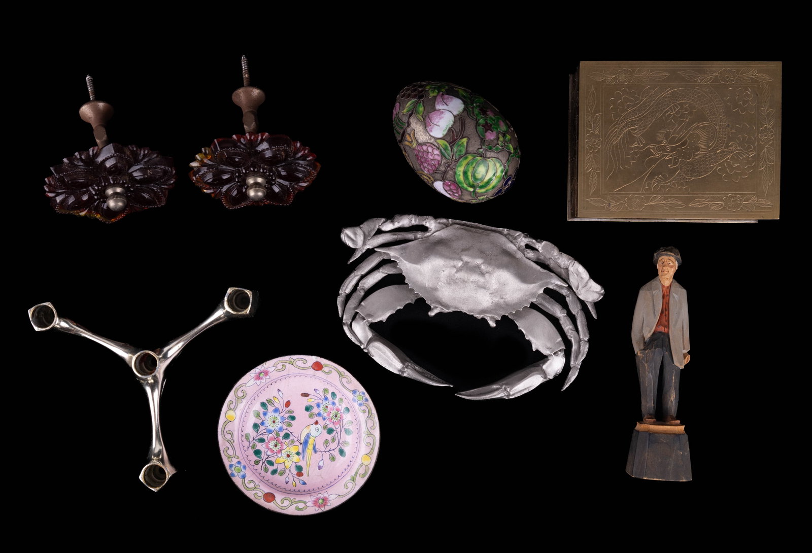 Agnes Dube Folk Art, Salisbury Pewter, & Others: Carved wooden folk art figurine signed by Agnes Tube Salisbury Pewter crab decoration, Cloisonne egg, Chinese cloisonne plate, pair of amberina glass curtain rod end pieces, candle holder, and brass a