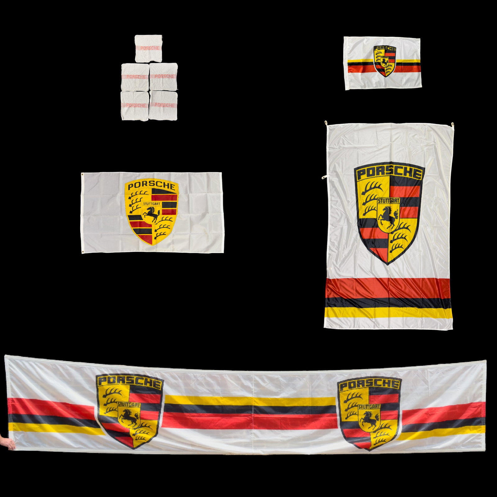 Vintage Porsche Flags, Banners, and Towels: Lot includes 2 banners, 2 flags, and 5 Porsche mechanic's towels. Largest banner measures approx. 14.5" L x 3" W.