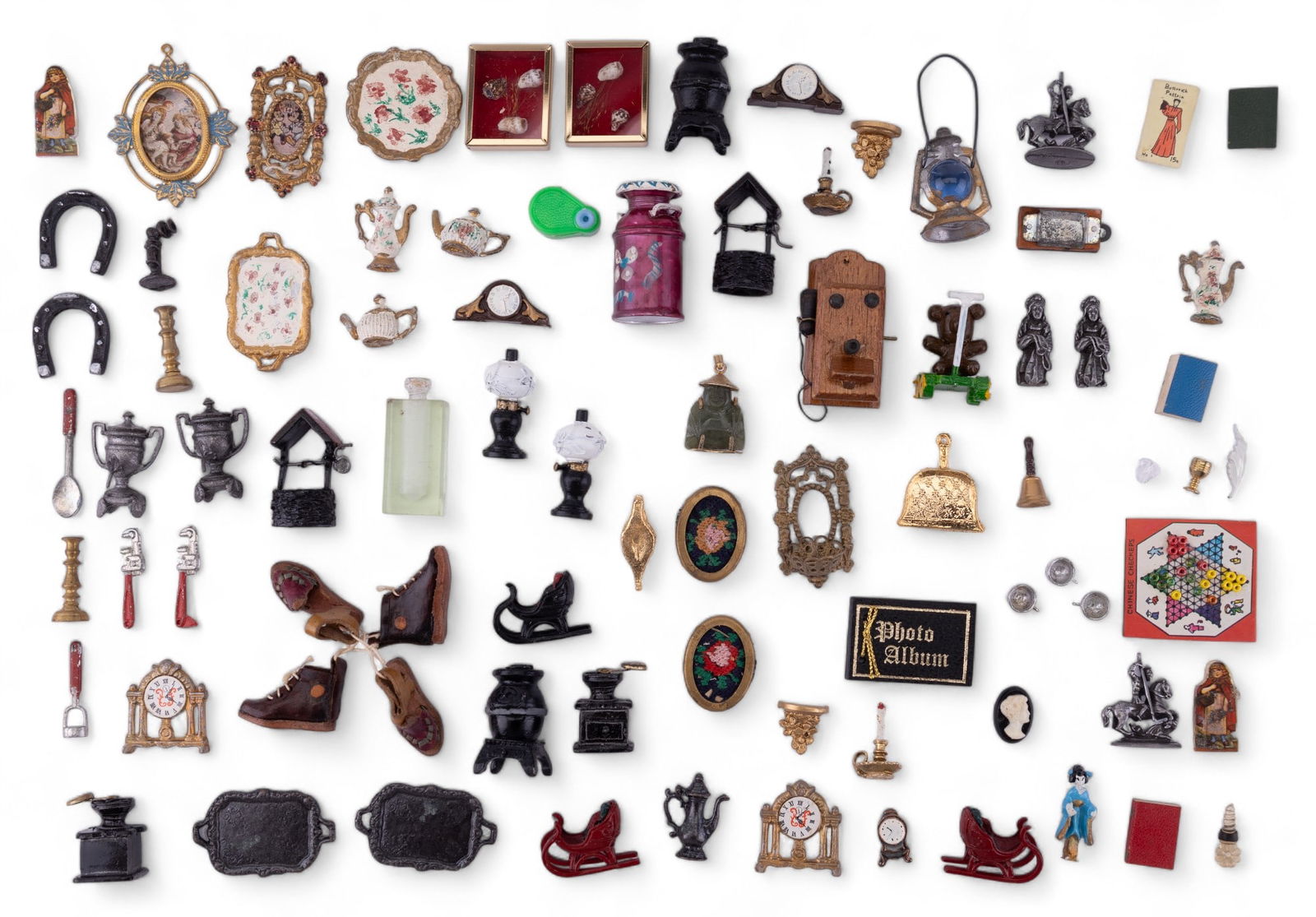 Doll House Accessories - Cast Metal, and Others: Mostly cast doll house accessories including clocks, tea pots, tea tray, statuary. Other items including shoes, wall clock, perfume bottle, and books. Dollhouse miniatures.