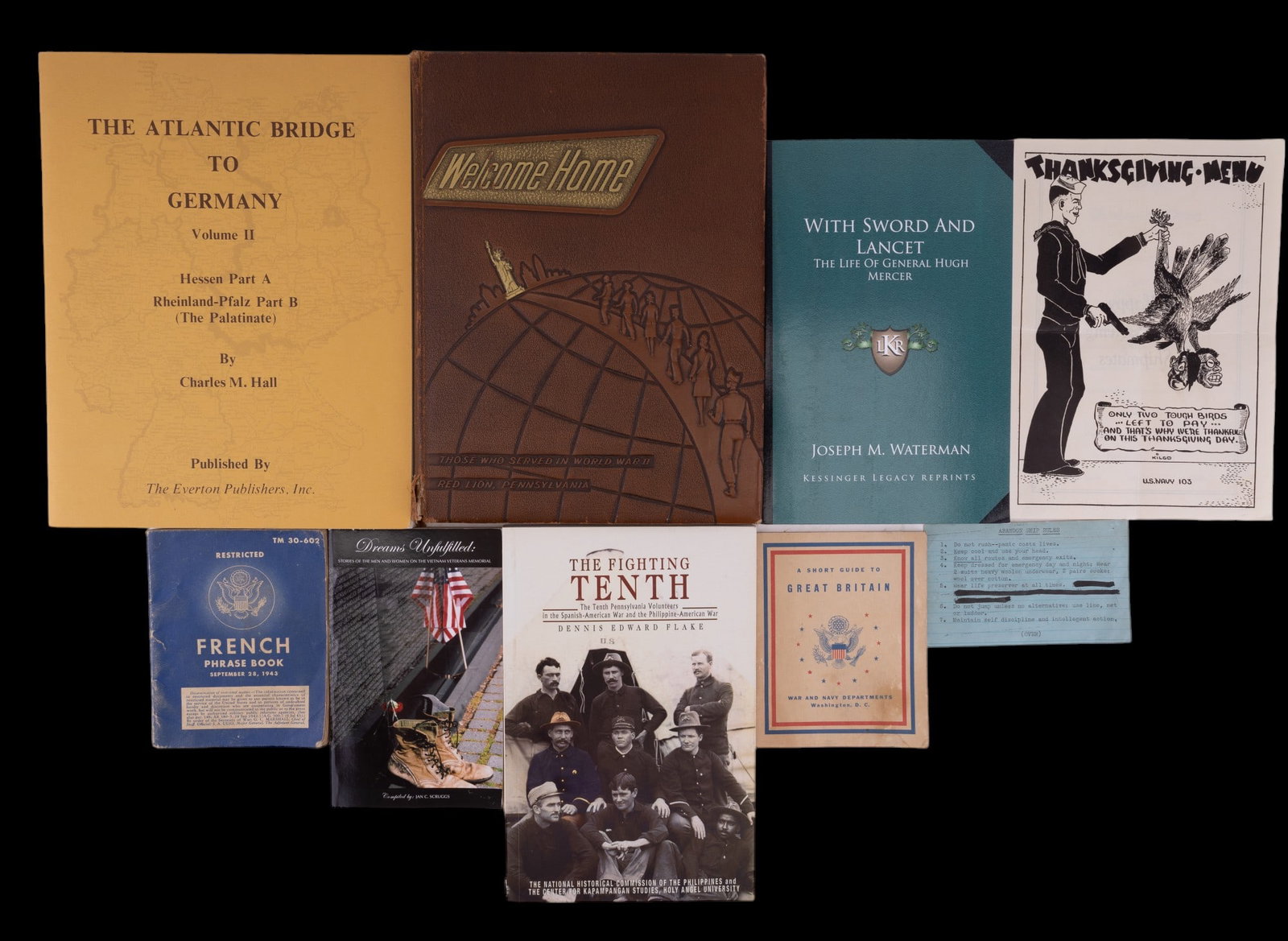 York PA WW II Books & Ephemera: York WW II books & ephemera. Nine items, including Red Lion PA Vets yearbook, a Navy menu from 1943, Vietnam Vets paperback.