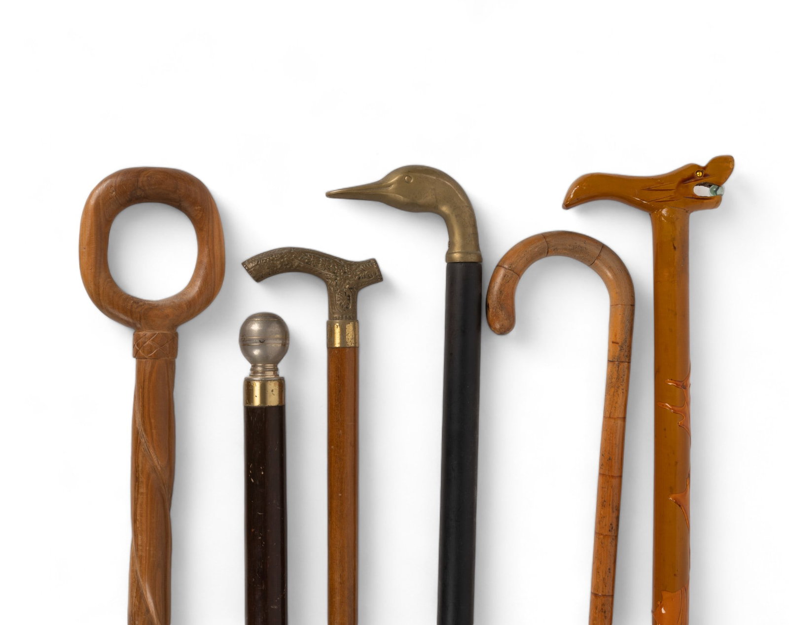 6 Collectable Canes: 6 Collectable Canes. Consists of dome top cane with storage compartment, figural animal cane holding marble, bamboo cane, goose head cane, and one other. Canes appear sturdy. Approx 36.5".