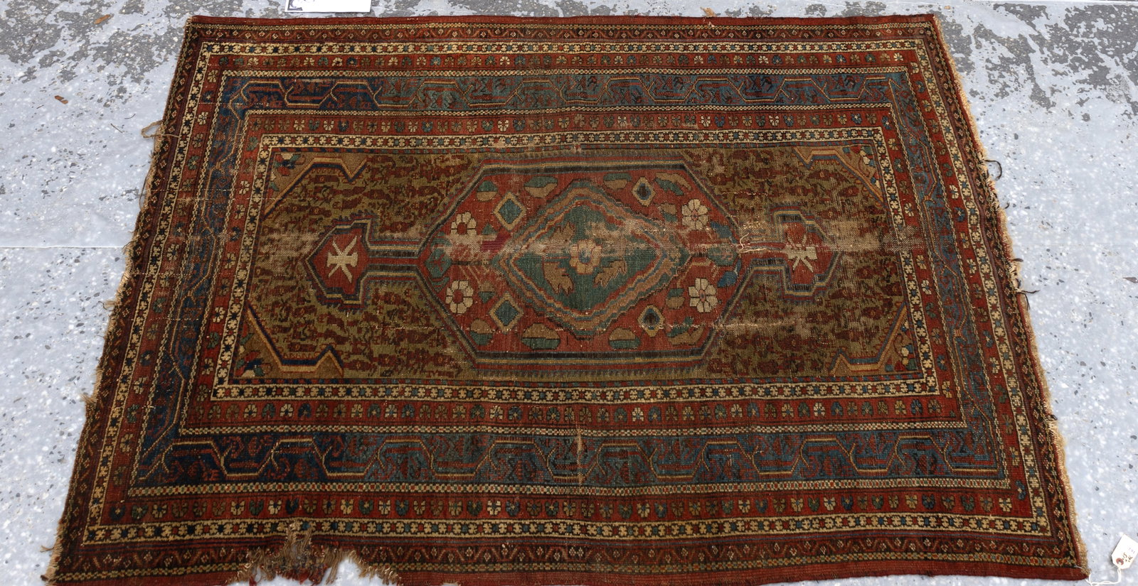 Antique Persian Rug: Approx. 79" x 51" antique Persian rug, slight fading, some extensive fringe damage on one side and slight damage on other sides. (As seen in photography).