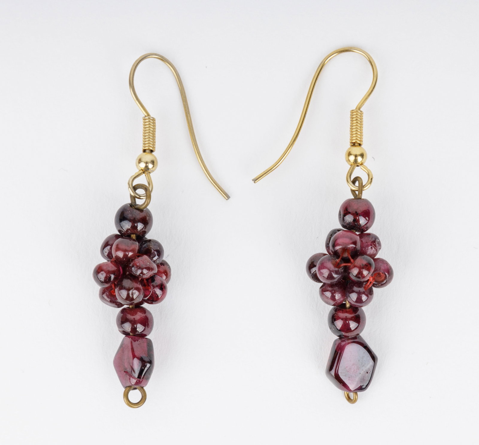14K Gold & Garnet Drop Earrings: 14K gold earrings with garnet stones. The earrings have an approx 1.75" drop.