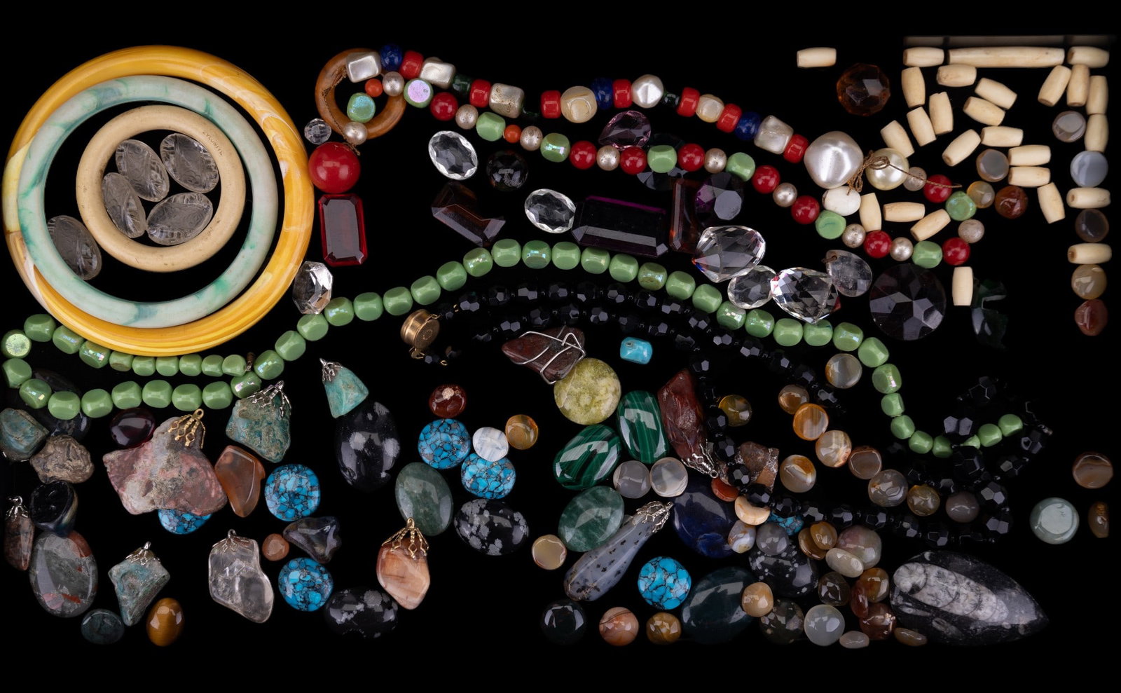 Semi Prec. Stones, Glass, Bone + Bangles: 100+ pieces, consisting of semi-precious pendants & cabochons, glass beaded necklaces, glass gems and beads, plastic bangles, bone beads & more.