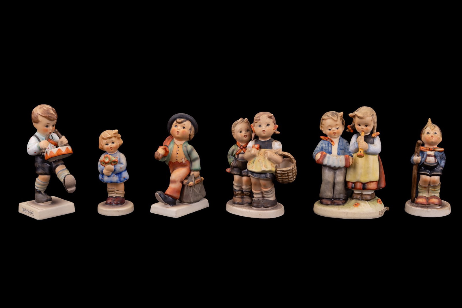 Goebel Hummel Figurines (6 Pc.): Sic Goebel Hummel figurines, including names: Little Hiker, Girl with nosegay, Merry Wanderer, To Market, Birthday Serenade, & Little drummer. All are marked with Goebel mark on bottom, no structural