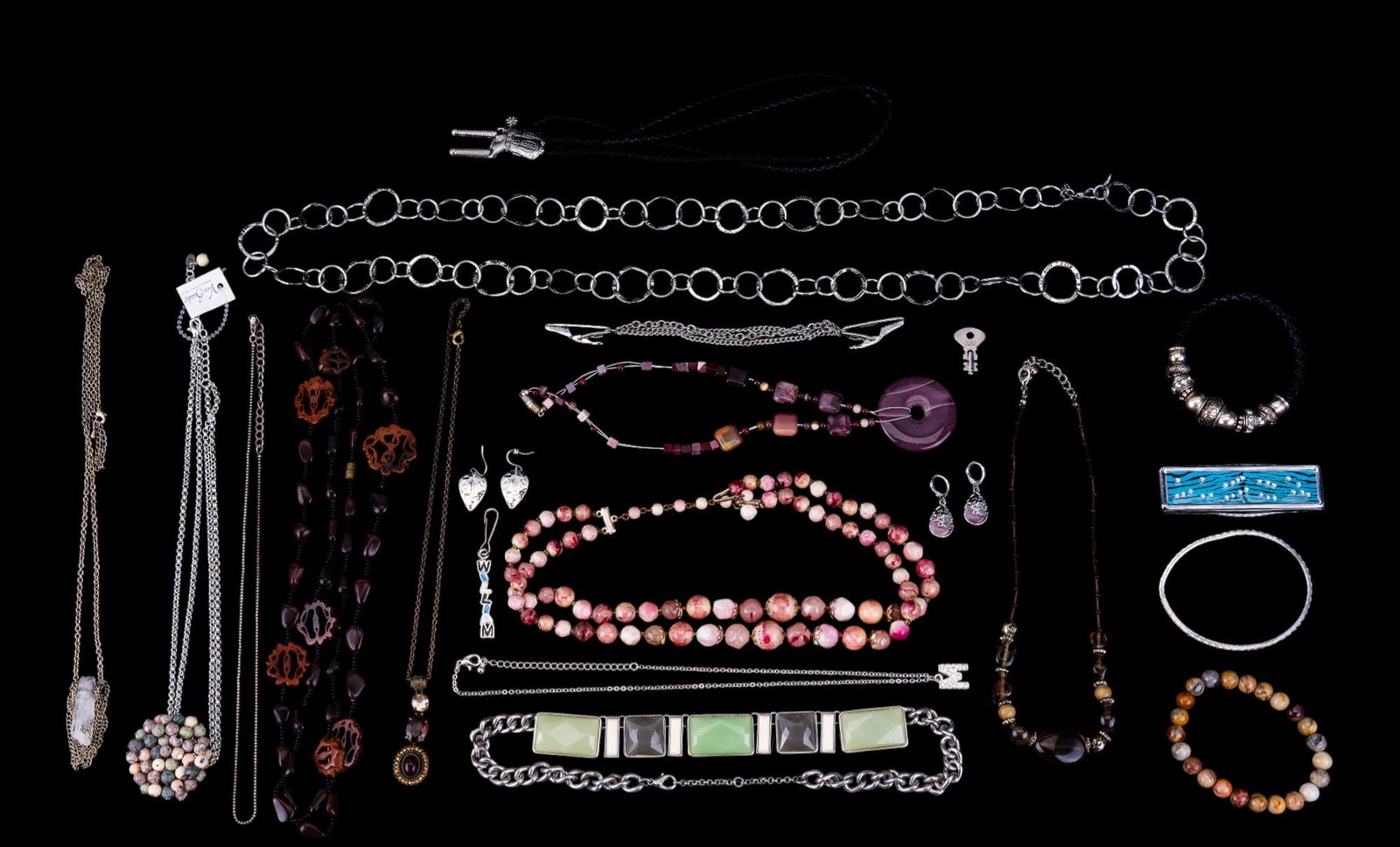 Various Silvertone & Other Costume Jewelry: Silvertone jewelry including a green and gray stone chain, a silvertone chain with colorful cluster pendant, "William" pendant bolo tie with silvertone boots, tie clip chain and more as seen in photog