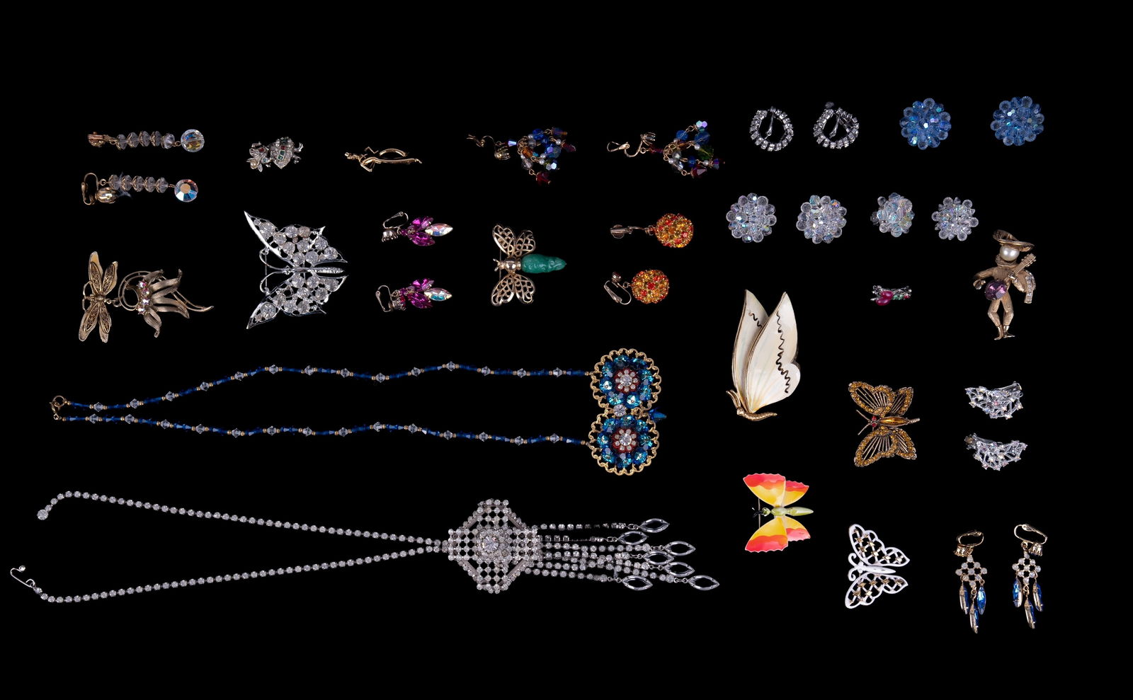 Vintage Trifari, Napier, and Estate Jewelry: Sampling includes vintage Trifari gold tone white winged butterfly brooch, early Napier minstrel playing instrument brooch, ornate crystal teardrop fringe necklace, colored rhinestone crystal earrings