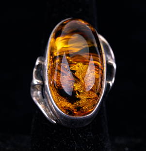 Large Baltic Amber Sterling Ring: A large baltic amber ring, set in unmarked sterling silver. Ring is approx size 8.