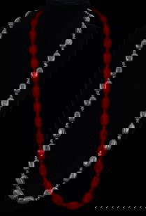 Polished Red Coral Bead Necklace: Long polished red coral necklace with silver unmarked closure.