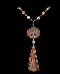 Crystal Necklace w/ Chinese Style Pendant: A champagne crystal necklace with a large brown jade pendant with a multi-crystal tassel drop.