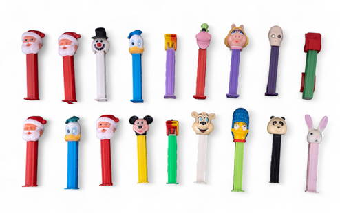 Vintage Pez Dispensers: 18 various Pez candy dispensers including Mickey Mouse, Goofy, Donald Duck, Dolad Duck w/ green hat, Miss Piggy, Marge Simpson, Dr. Skull, Santa Claus (4x, 2 are missing eyes), Icee Polar Bear, Snowma