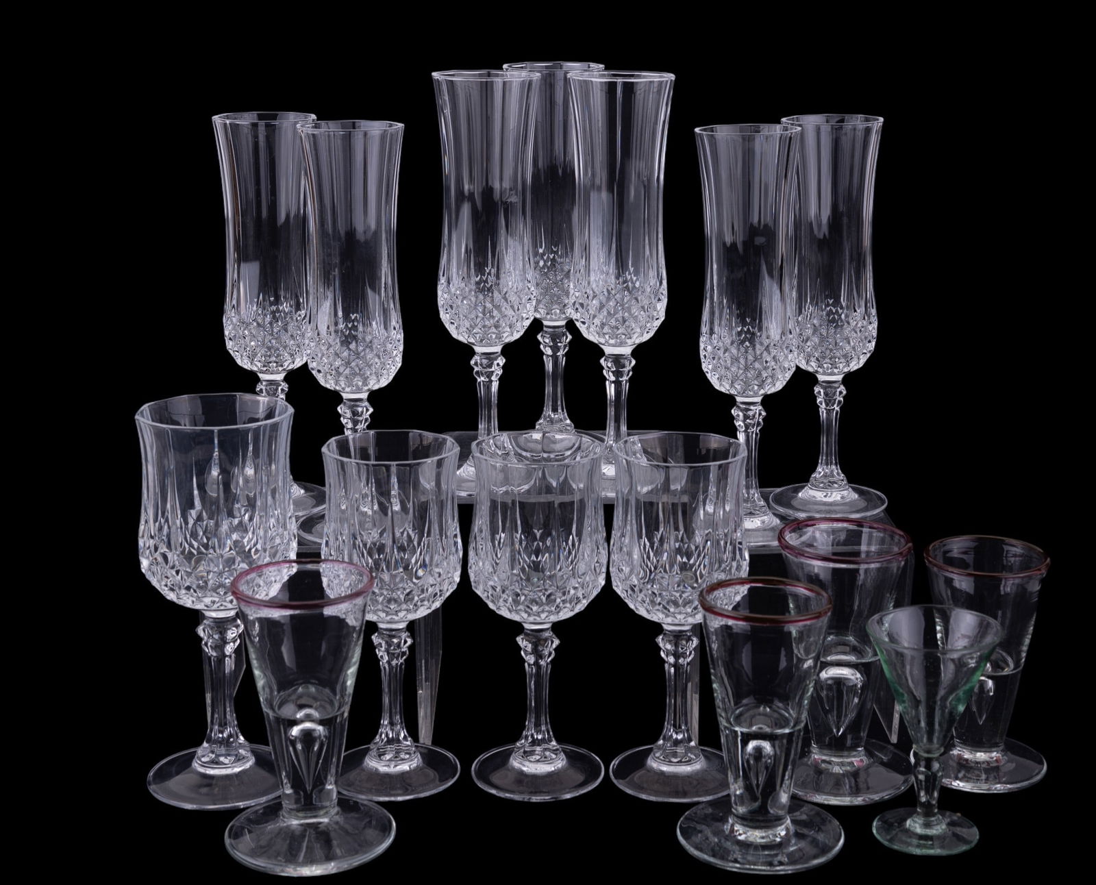Lead Crystal & Art Glass Stemware (16 Pc.): Grouping includes seven crystal champagne flutes, three small crystal wine glasses, and a large wine glass, along with four art glass handblown bubble base cordial glasses, and a hand blown green cord