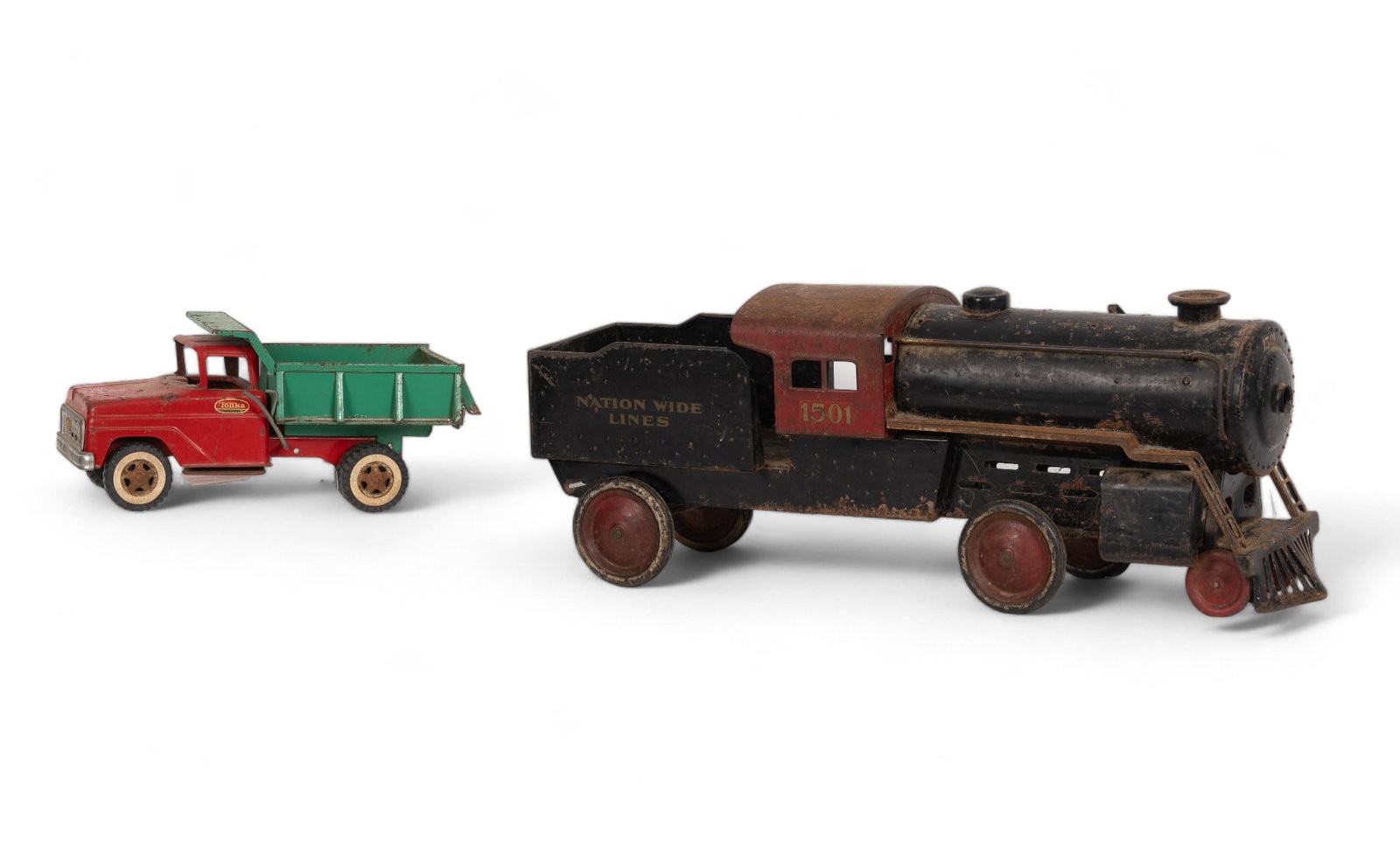 Antique Pressed Steel Toys (2): 1 "Steelcraft" Sit-on Ride "Nationwide Lines" 1501 Locomotive. Measures 28 1/4" long. Condition is good, steering is working. A section of front left tire is missing, along with two small brackets on 