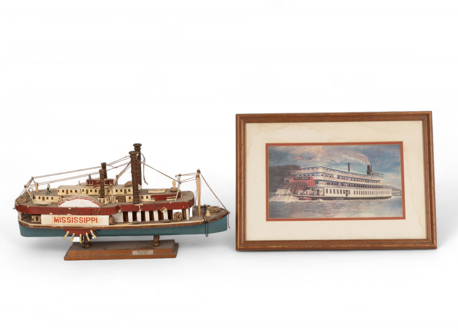 Vintage Mississippi Riverboat Model & Art: Riverboat model is in overall good/fair condition (needs minor repairs to some damaged areas) and measures approx 21" long, 6" wide, & 11" tall. Framed riverboat art has staining and measures approx 2