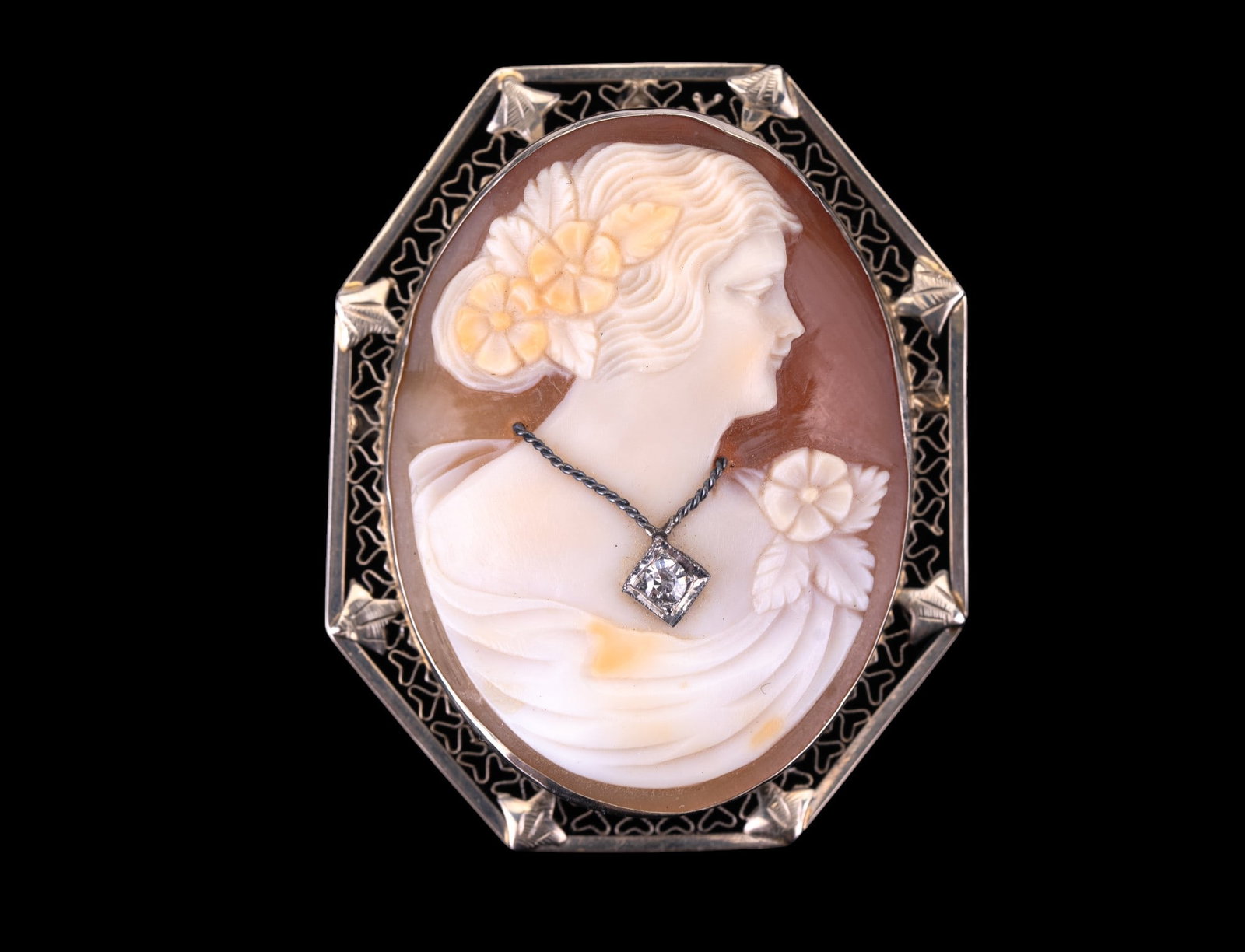 14K Gold Diamond Cameo Brooch: 14K gold cameo brooch with diamond (approx. 3mm dia) on hidden bail loop. Total weight of 8.8 g. Brooch measures approx 1.75" x .9375".