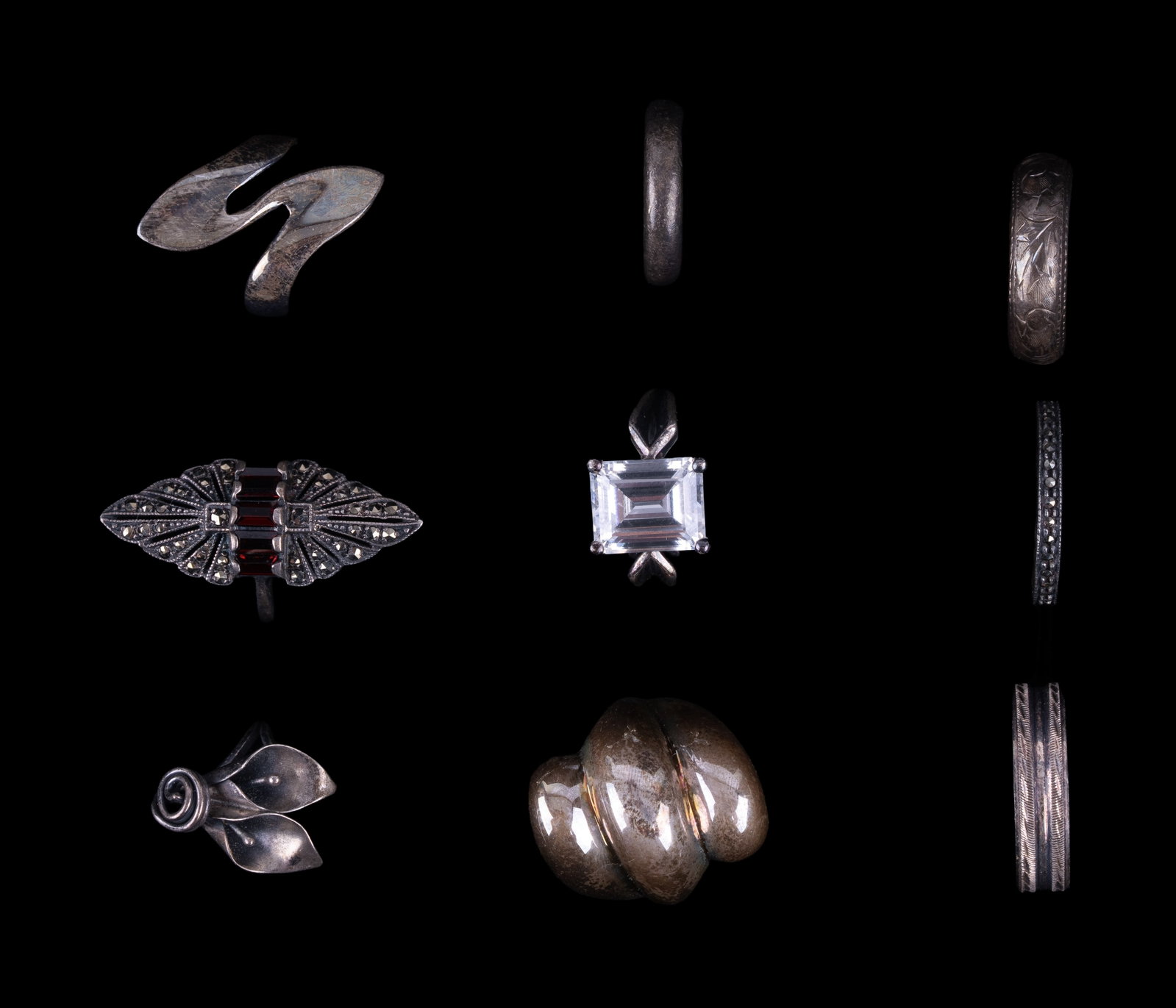 Sterling Silver Rings (9): 9 marked sterling rings with stones testing as garnet, topaz, and CZ, and various floral and other designs.