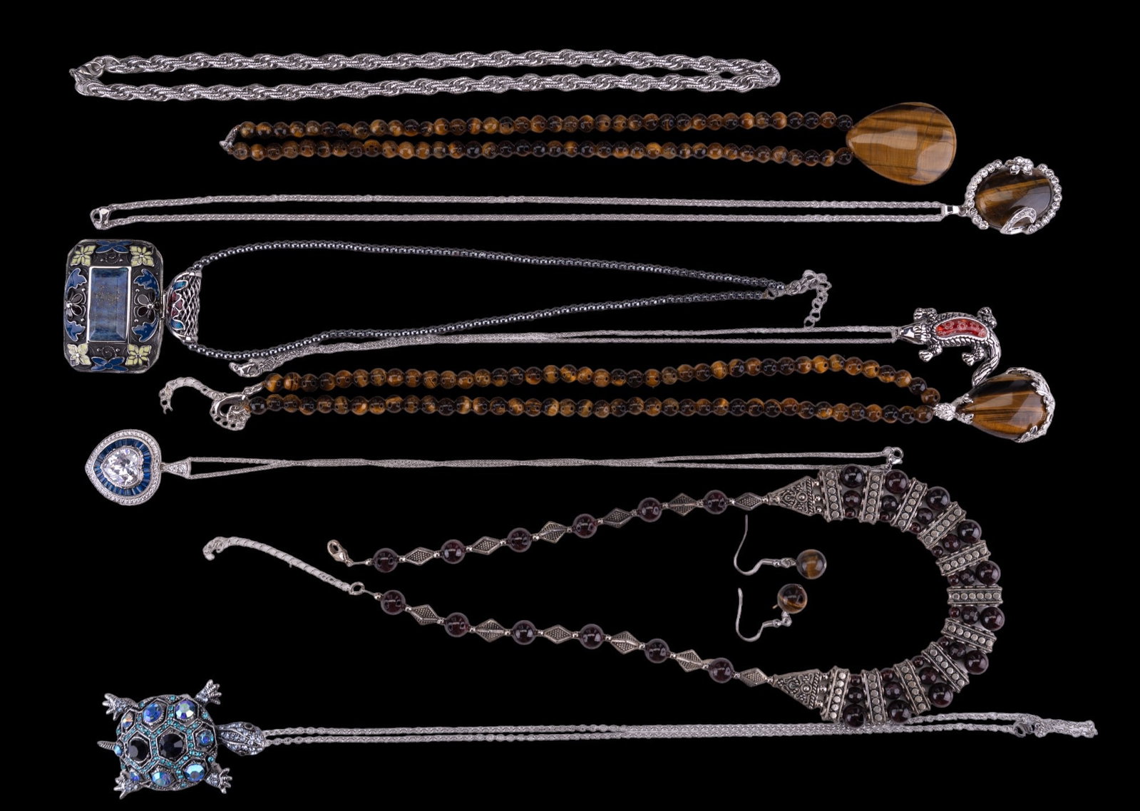 Semi-Precious & Rhinestone Jewelry: Semi-Precious & Rhinestone Jewelry. Eight (8) necklaces of garnet, tiger eye, lapis, rhinestone, & art glass, with one pair tiger eye earrings, and also a stainless steel rope necklace.