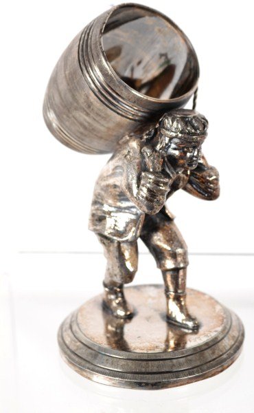 Victorian Figural Napkin Ring: Victorian figural napkin ring of a man carrying a barrel with rope (loss to half of the rope)