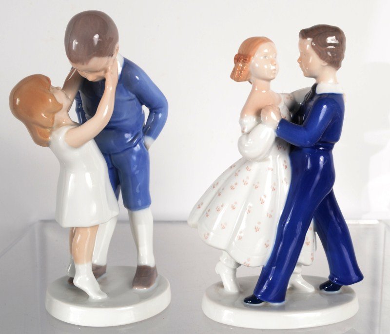 Two Bing & Grondahl Figures: First figure is of a little girl kissing a boy, marked Copenhagen B&G and signed, 8 1/2" tall: Second is of a man and woman dancing, marked B&G and signed, 7.75"tall