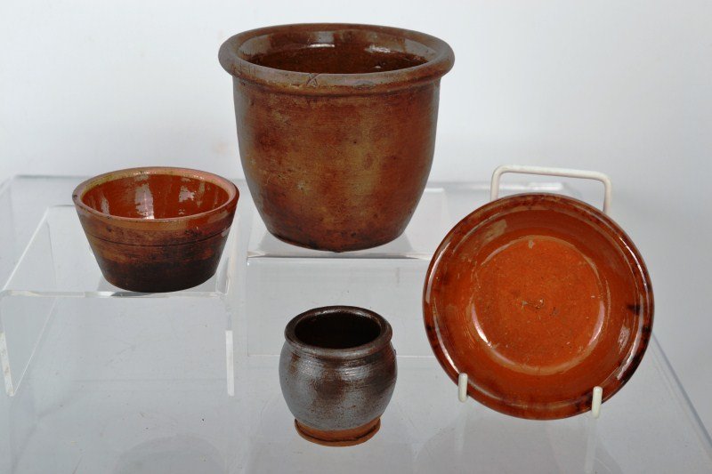 Two Miniature Redware Crocks, miniature Redware Bo: Two miniature redware crocks, one with manganese glaze, a miniature redware cup with slipware decoration, redware shallow bowl 4" dia written "Found in Berks County" tallest crock is 3 1/2"h